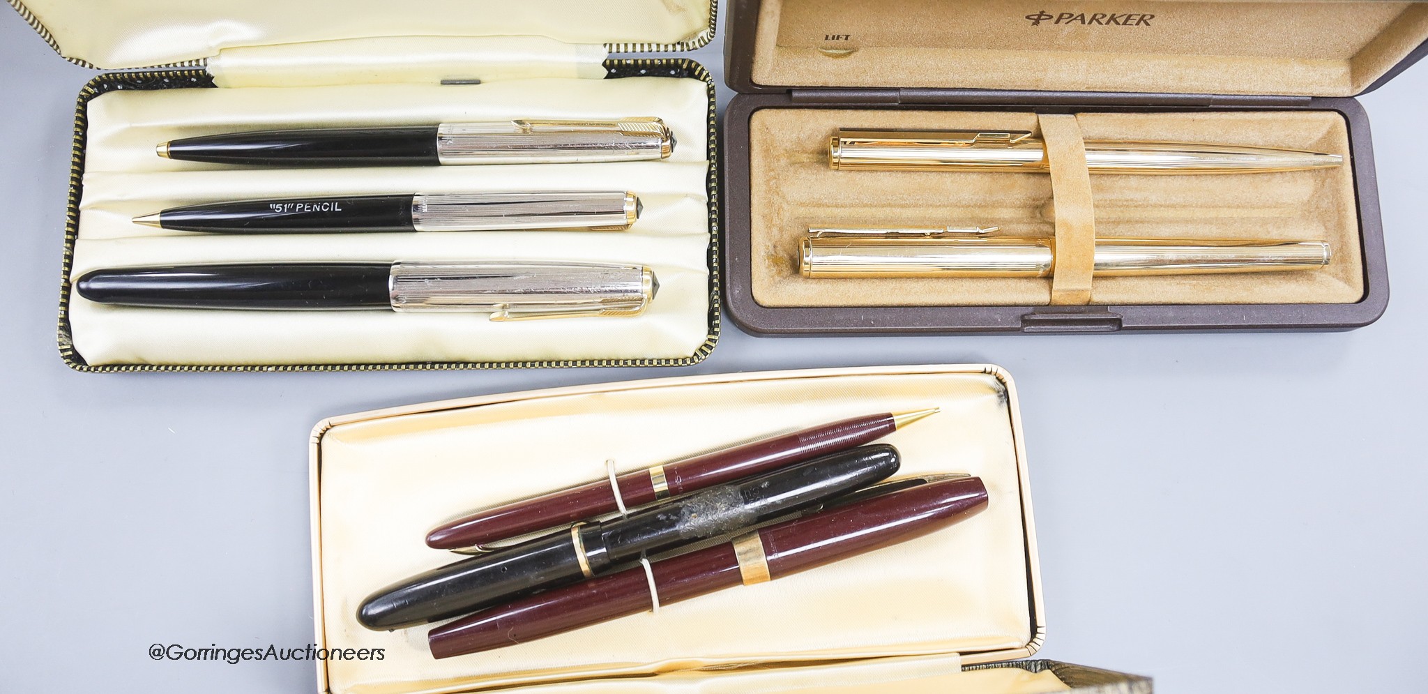 A group of three cased pens / pencils